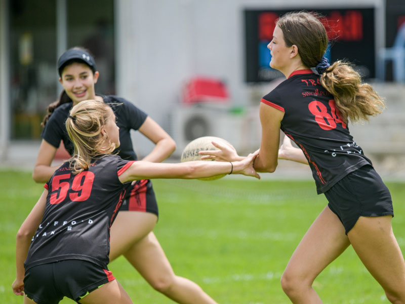 teenage girls in game of touch rugby