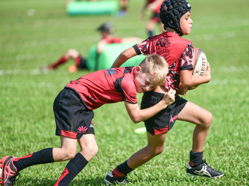 young boys in action playing rugby for kids