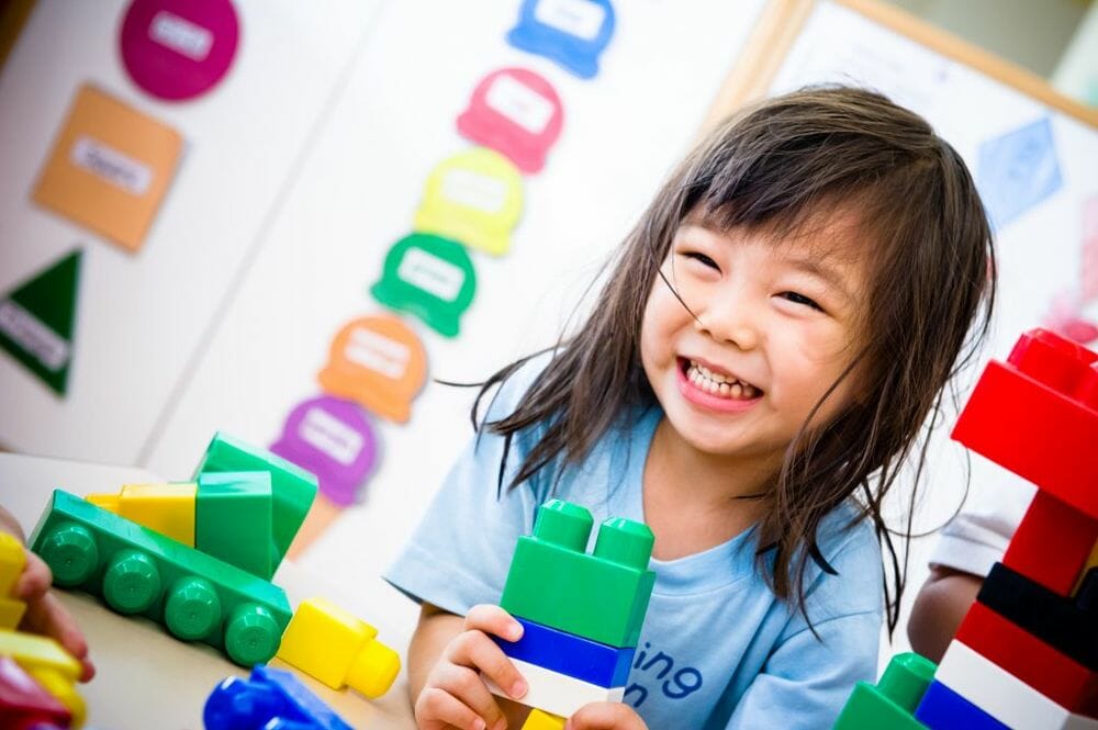 Kid with building blocks busy bees preschool singapore