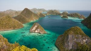 Limestone islands form a remote lagoon in northern Raja Ampat, Indonesia.