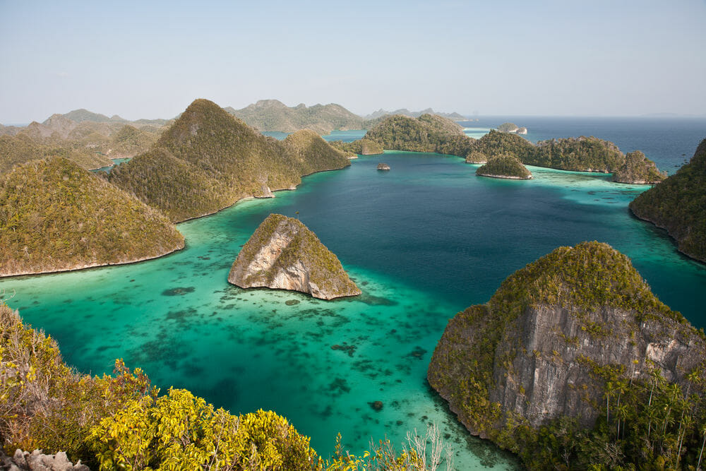 Limestone islands form a remote lagoon in northern Raja Ampat, Indonesia. 
