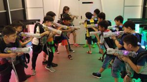 Laser tag players with guns prepare to play