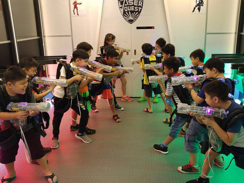 Laser tag players with guns prepare to play
