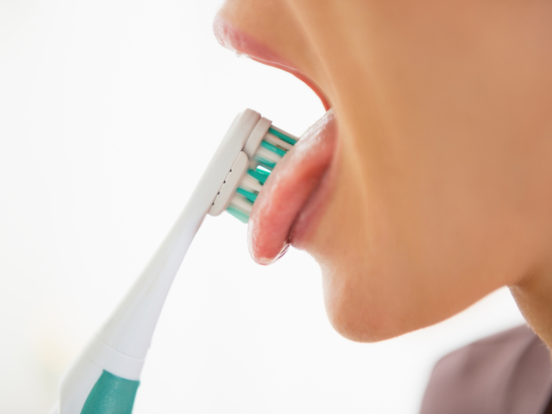 tongue scraping and brushing with fluoride toothpaste