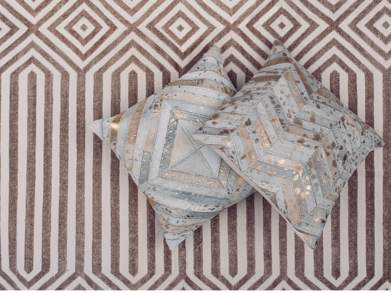 Chenille cotton dhurrie rug (1.8m x 2.75m), $1,350, and cowhide cushion covers, $120 each, The Cinnamon Room