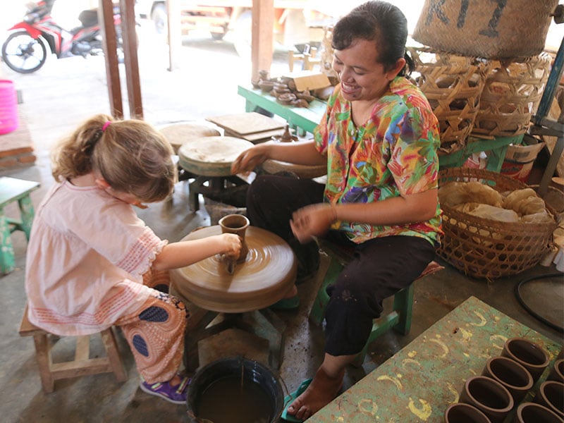 image of child having pottery lesson in Java's borobudur 