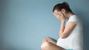 image of woman feeling stressed for 'pregnancy shaming' story
