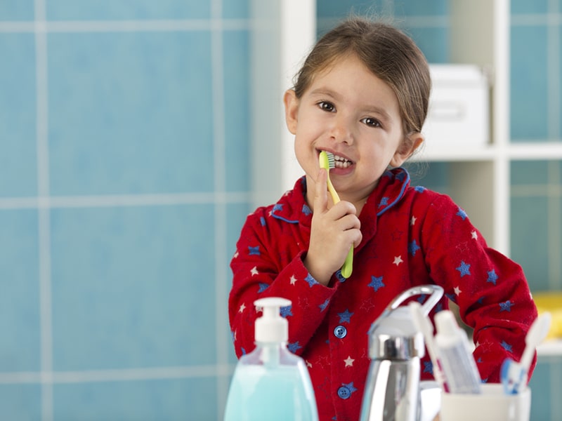 Pacific Prime dental insurance girl brushing teeth