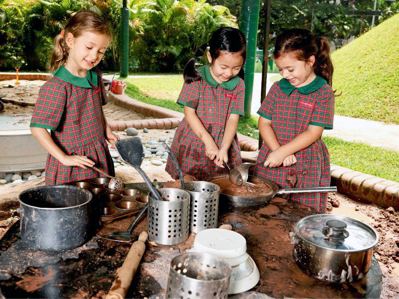 EtonHouse cooking in the mud kitchen preschool curriculum