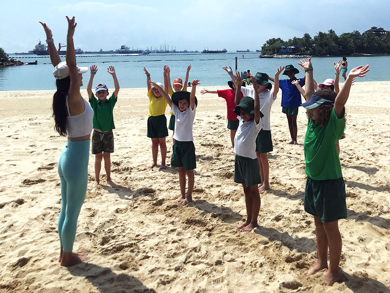 EtonHouse students yoga on beach