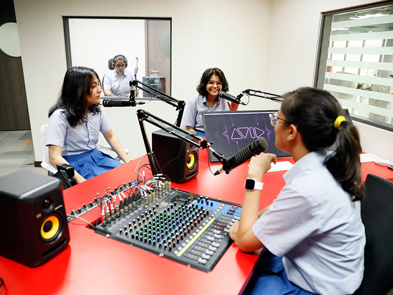 Global Indian School female students in recording studio international school curriculum