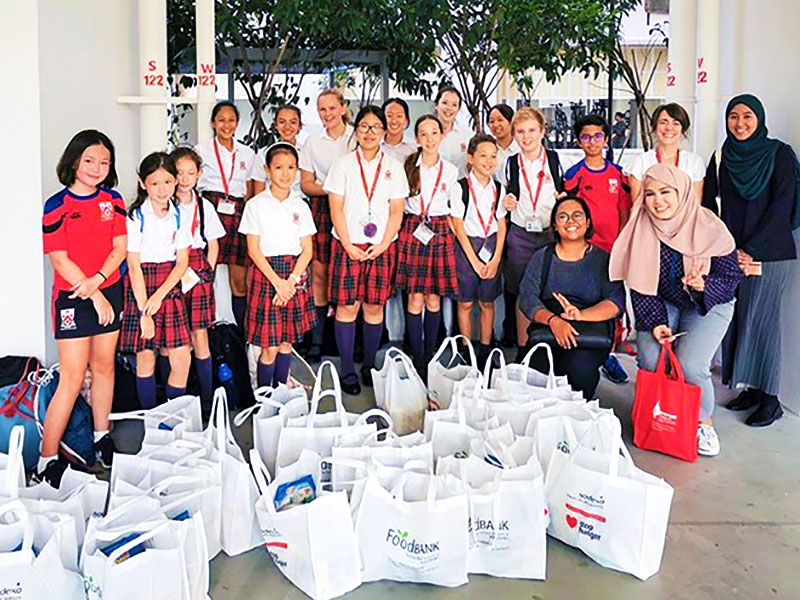 Dulwich College Singapore Junior School students helping at the Food Bank service learning