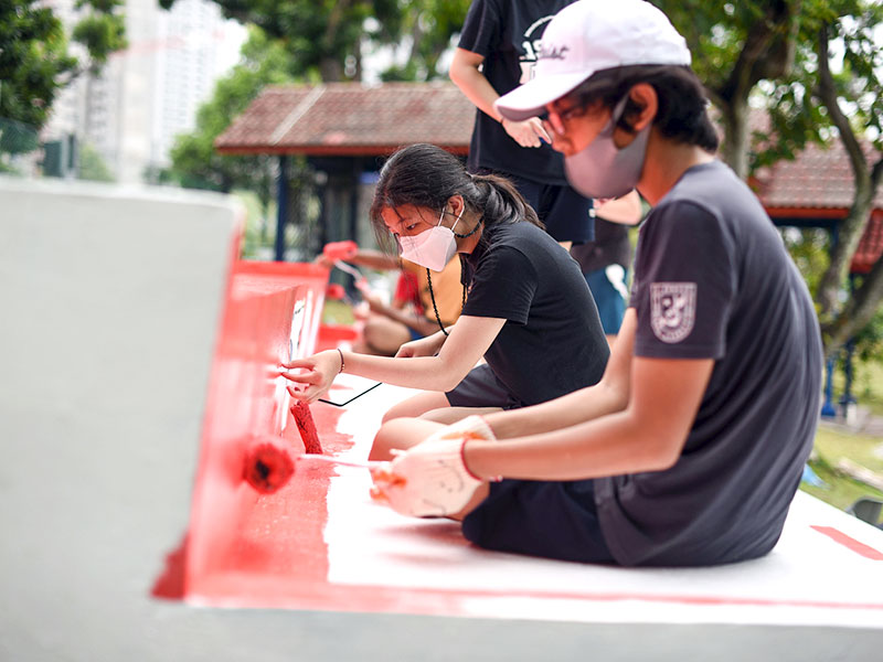International Community School students painting community work project