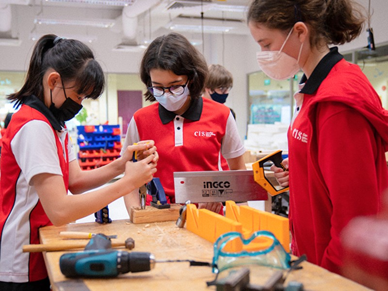 Canadian International School female students using tools for STEAM project