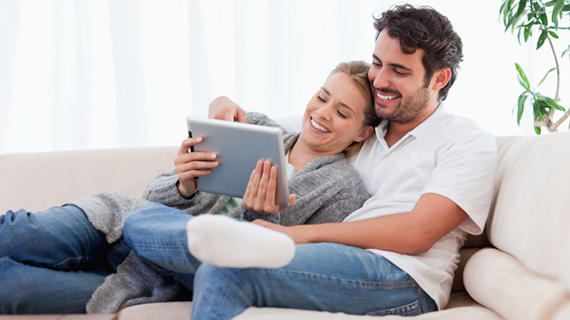 Couple using tablet iSwitch electrcity retailers