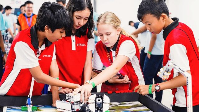 Group of Canadian International School students discussing STEAM project