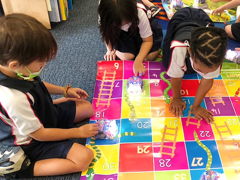 Stamford American International School programme students playing snakes & ladders