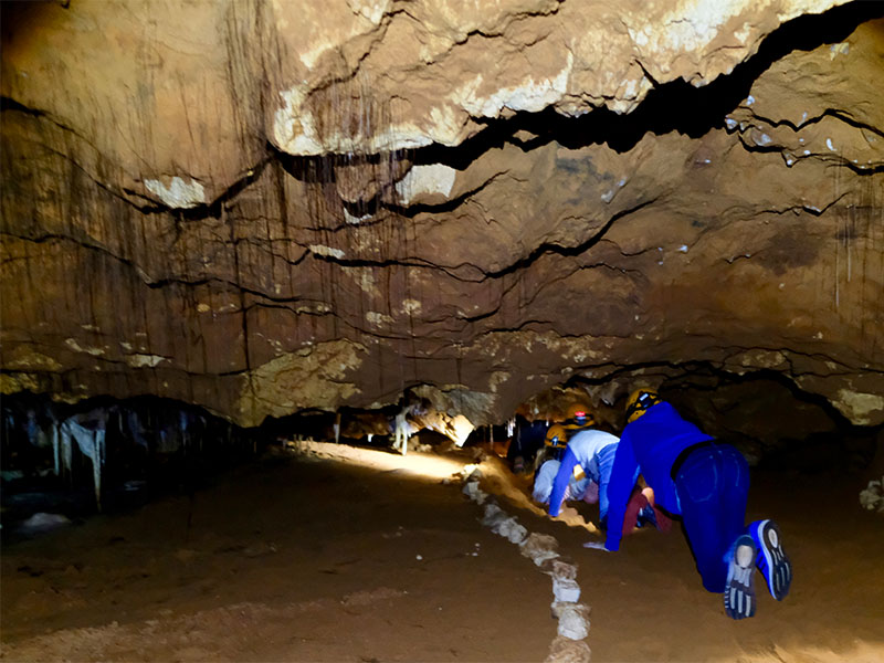 Crawling along the ancient river bed of Ngilgi Cave