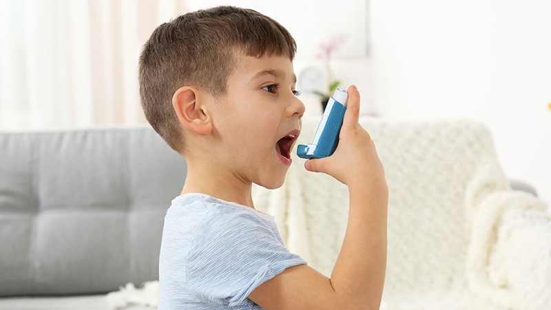 Little boy using inhaler asthma