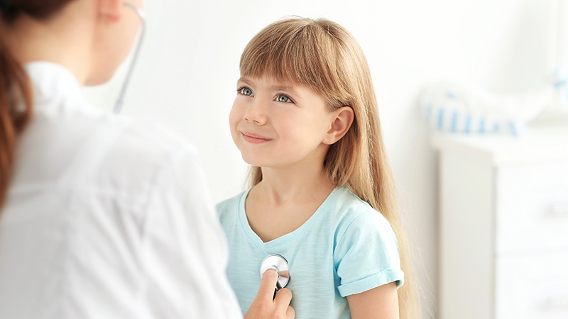 Children’s health screenings girl and doctor stethoscope