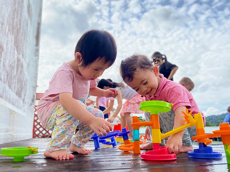 two kids at outdoor play activities at Mosaic Preschool