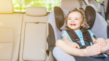 :aughing female child in child car seat Singapore