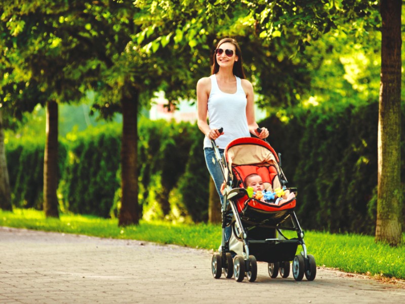 mother walking with baby in stroller how to clean baby stroller