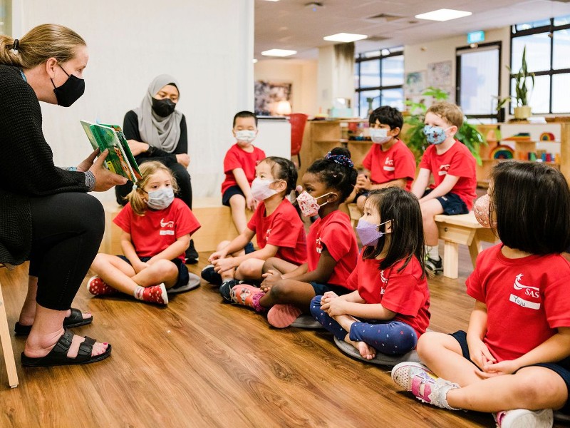 Singapore American School Early Learning Center nursery students at story time with teacher
