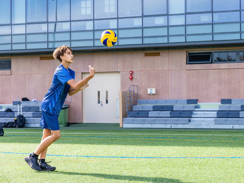 student on field playing volleyball at North London Collegiate School (Singapore)