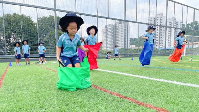 sports schools in singapore students jumping sack sports activities