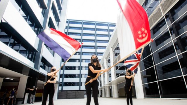 OFS Singapore international school students waving country flags