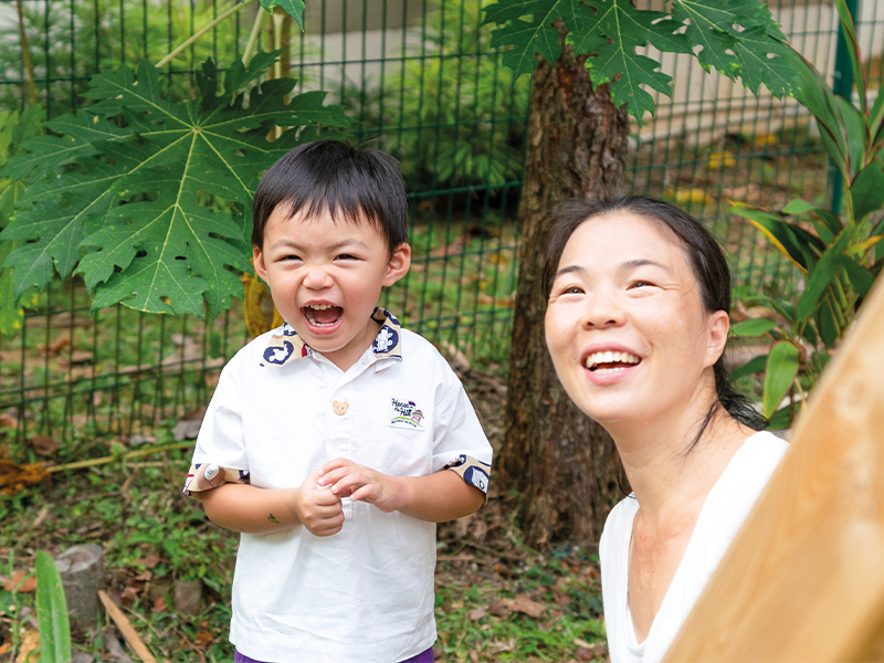 House on the Hill student & teacher laughing Singapore Montessori