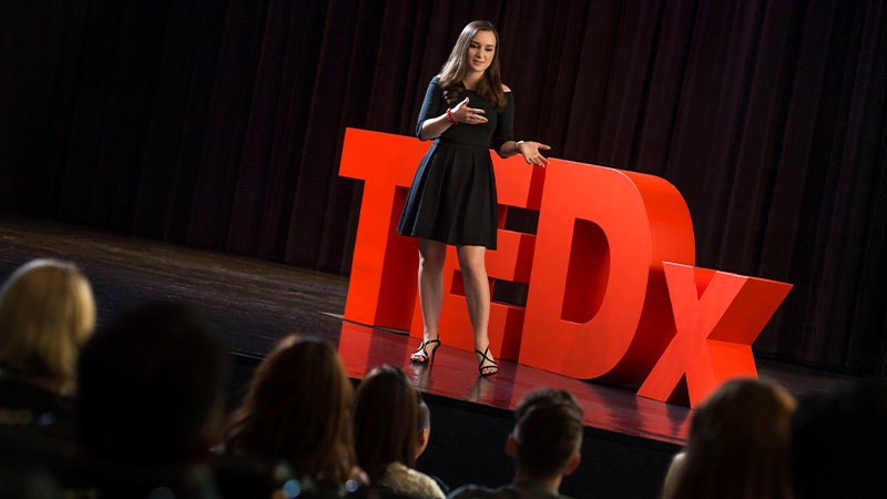 SAS student showing American schooling communication learning goals at TEDx