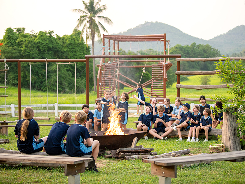 Rugby School Thailand boarding schools in Thailand pupils around outdoor campfire