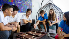 UWCSEA boarding school in Singapore students playing backgammon in common room
