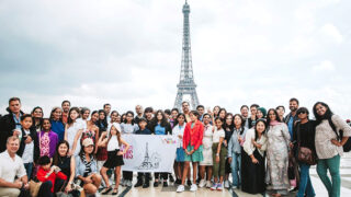 little artists in front of eiffel tower paris