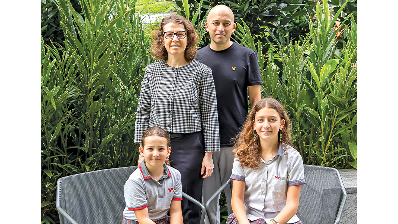 image of parents with daughters at XCL World Academy Singapore