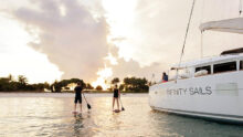 renting a yacht in Singapore sunset paddle board activity - Sing Yachts